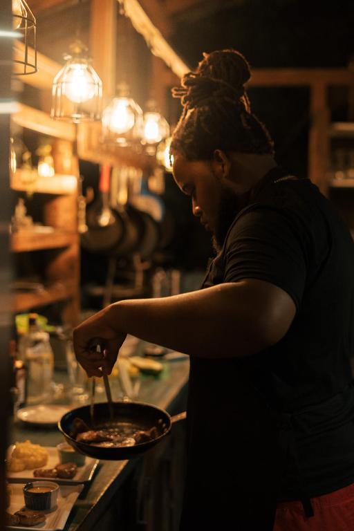 a woman is preparing food in a kitchen at ZÂRIA Hotel & Retreat Center in El Valle