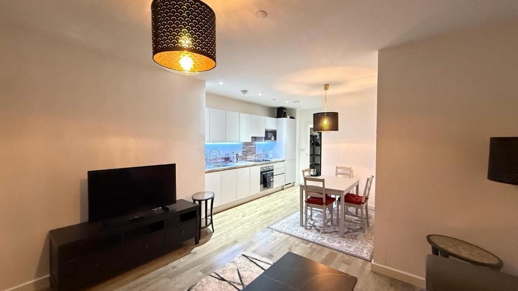a living room with a television and a dining room at Luxury Stay ,London ,Wembley Stadium BOOk now in London