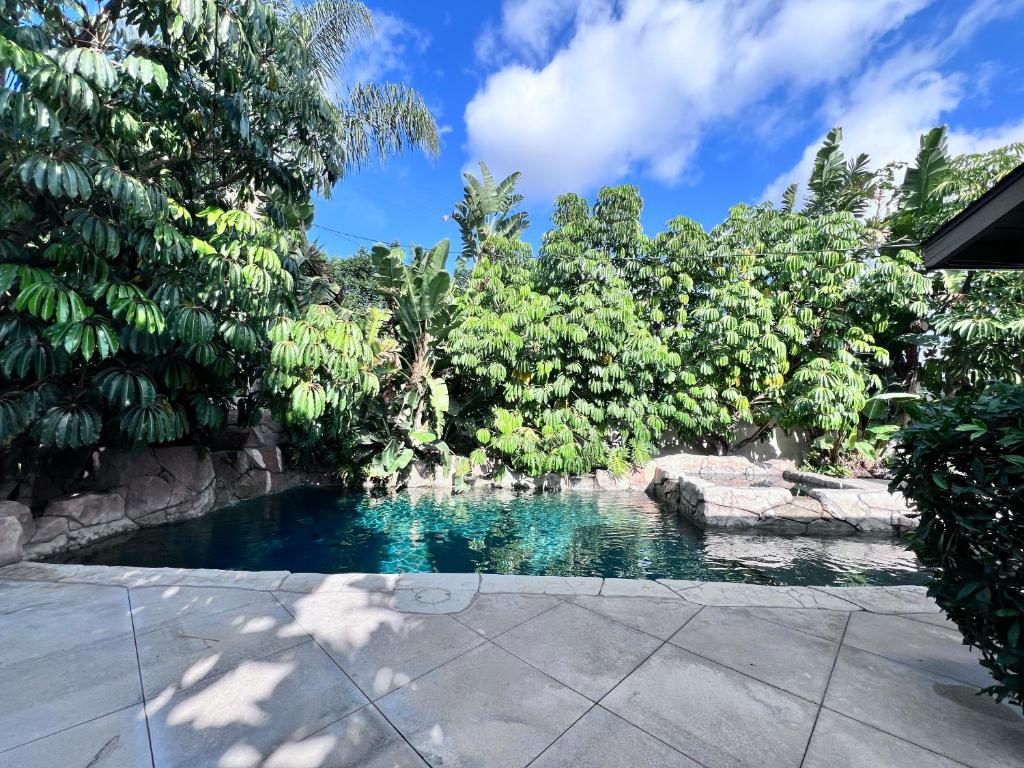 a swimming pool in a garden with trees at Amazing 5 bedroom, 1/2 Mile To Disneyland 1/4 mile to Anaheim Convention Ctr in Anaheim