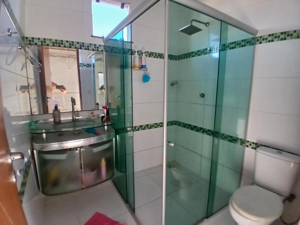 a bathroom with a shower and a toilet and a sink at Angelo&Gabi in Ananindeua