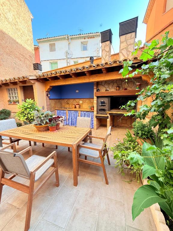 a wooden table and chairs on a patio at Casa Rural MIÑONAS in Ibdes