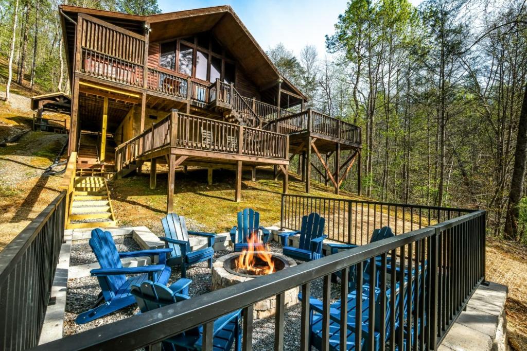 a deck with chairs and a fire pit in front of a house at Amazing Grace in Sevierville