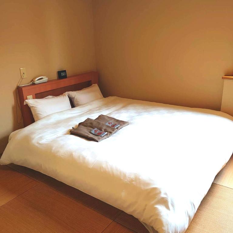 Postel nebo postele na pokoji v ubytování Concept Hotel Wakyu