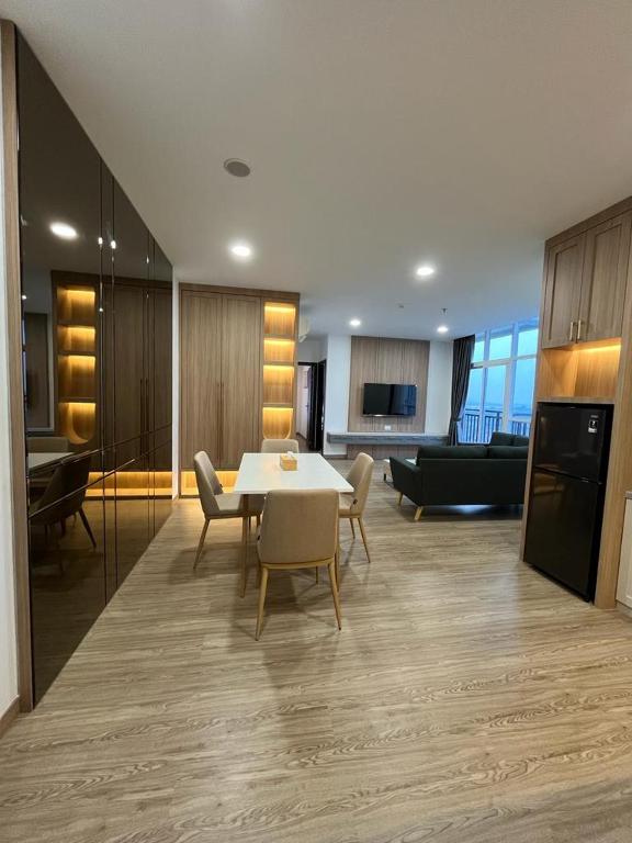 a living room with a table and chairs and a couch at Cozy Apartment in Batam in Jodoh