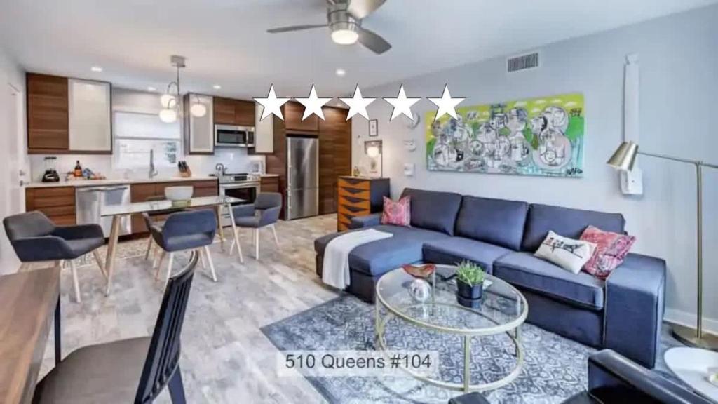 a living room with a blue couch and a table at Chic and Relaxing 1BR in the Heart of Myers Park in Charlotte
