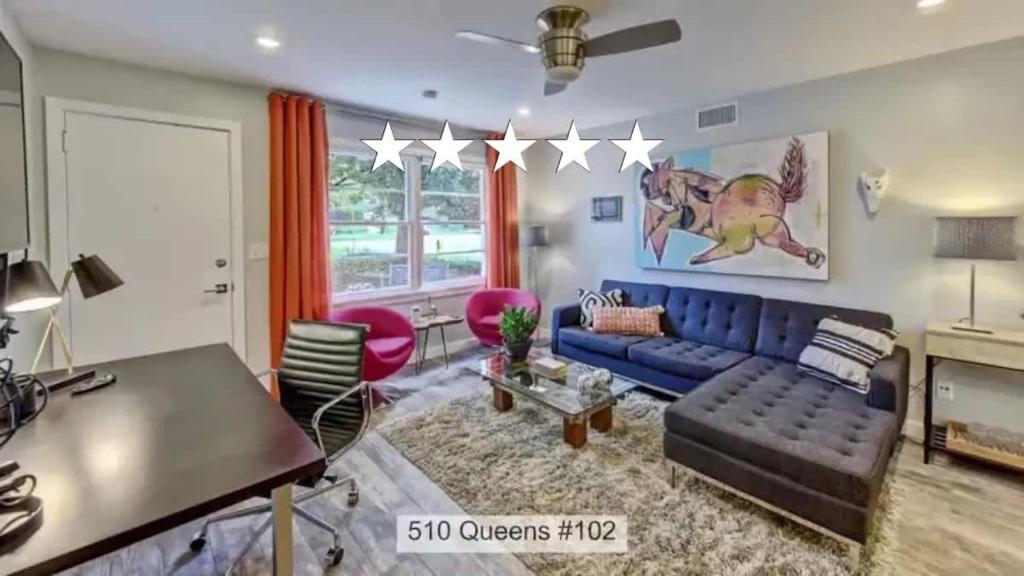 a living room with a blue couch and a table at Spacious condo with easy access to Uptown in Charlotte