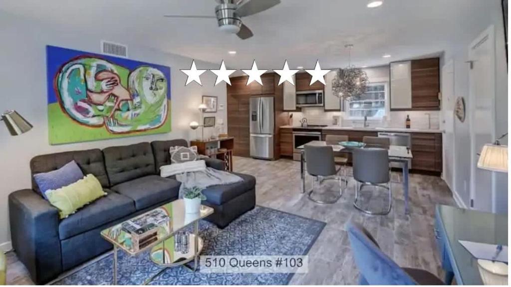 a living room with a couch and a kitchen at Spacious Conveniently Located 1BR in Myers Park in Charlotte
