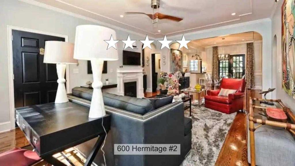 a living room with a leather couch and a fireplace at Relax or Entertain in Luxurious 2BR with Patio in Charlotte
