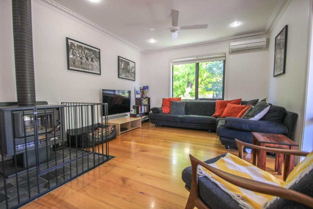 a living room with a couch and a tv at Mountbatten Retreat in Bright