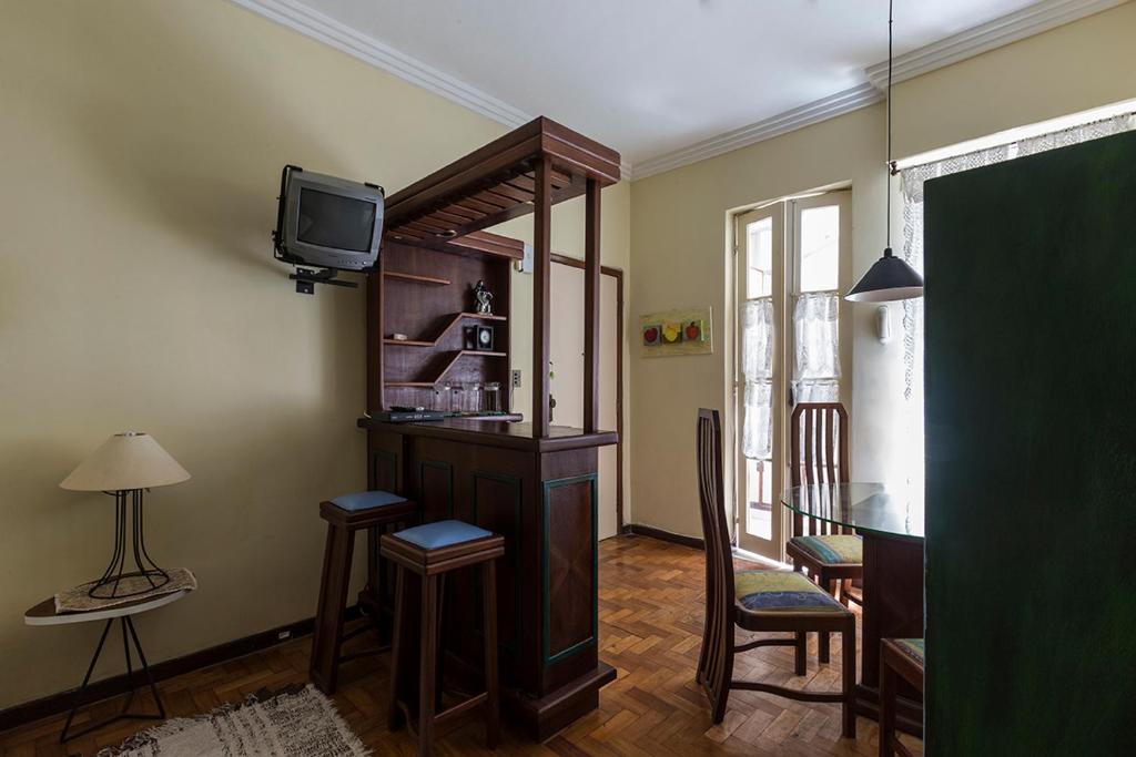 sala de estar con TV, mesa y sillas en Apartamento No Leme, en Río de Janeiro