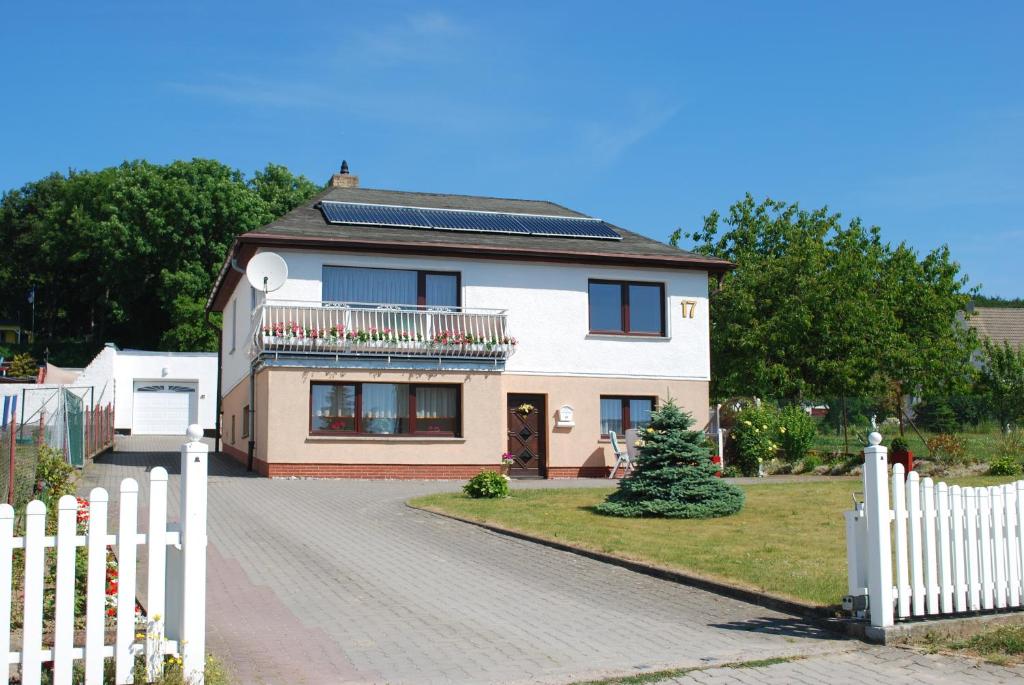 a house with a white fence in front of it at Ferienunterkünfte Familie Panter in Sassnitz