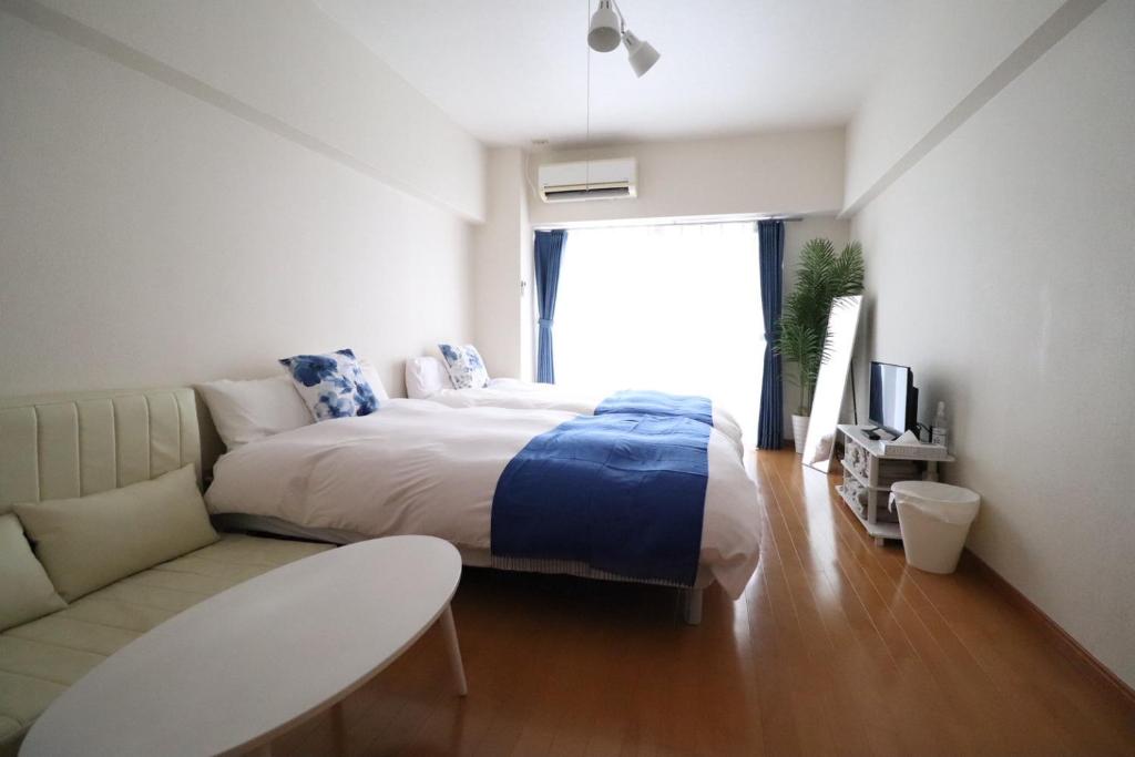 En eller flere senge i et værelse på ロイヤルハイツ春日