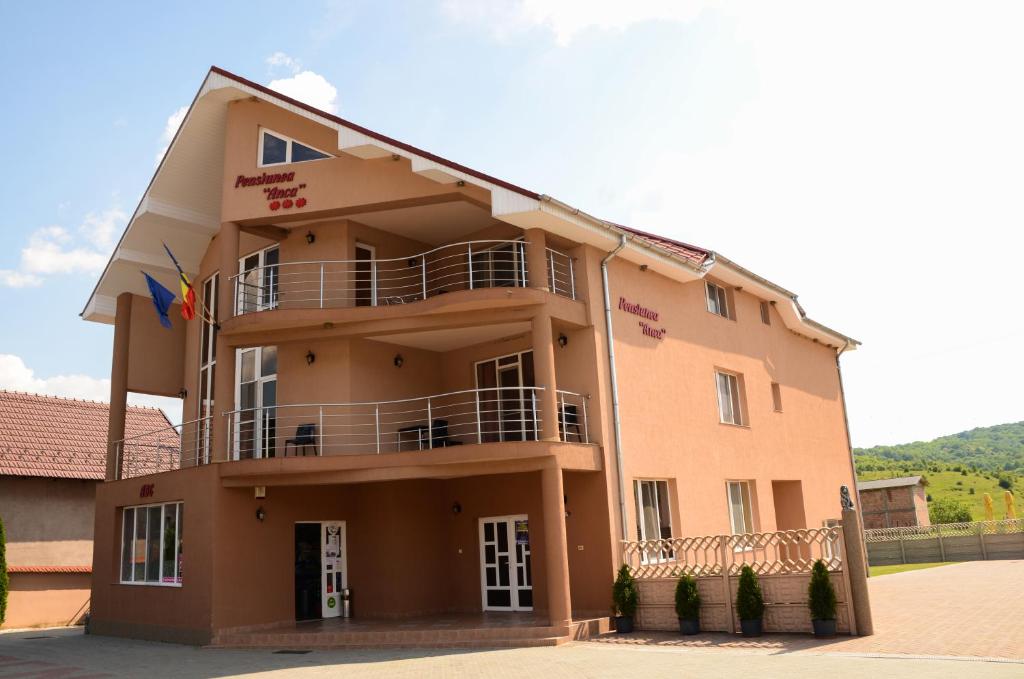 a large building with balconies on the side of it at Pensiunea Anca in Baile Felix