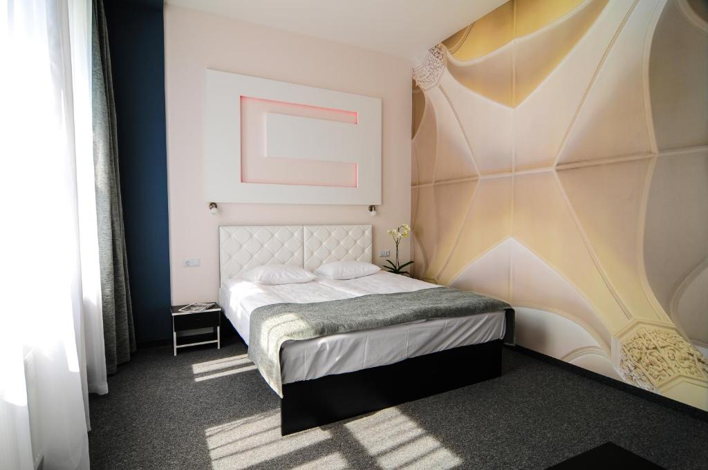 Postel nebo postele na pokoji v ubytování Homelike Hotel