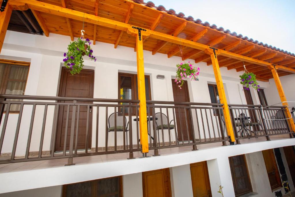 a balcony of a house with flowers on it at Psarotherma Rooms in Samothraki