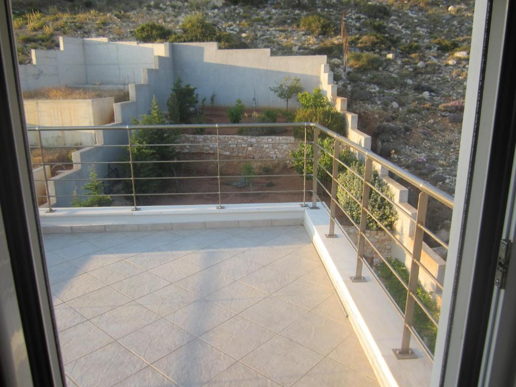 a balcony with stairs and a view of a building at Viva B&B in Anavyssos