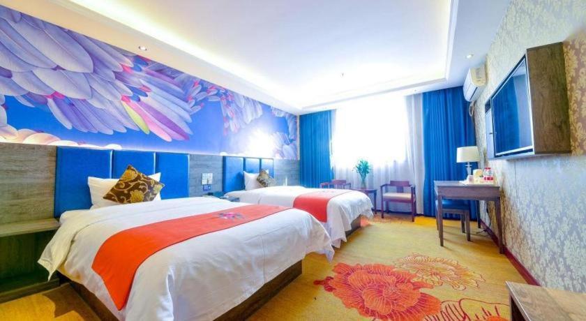 a hotel room with two beds and a mural at PAI Hotel·Luoyang Dingding Bei Road Hongjin Logistics International Peony Garden in Luoyang