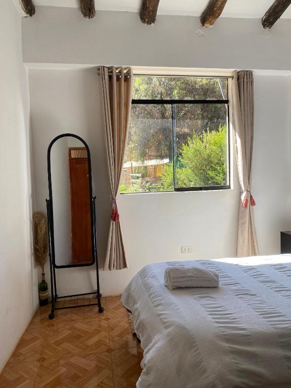 Postel nebo postele na pokoji v ubytování Colibri Wasi Pisac