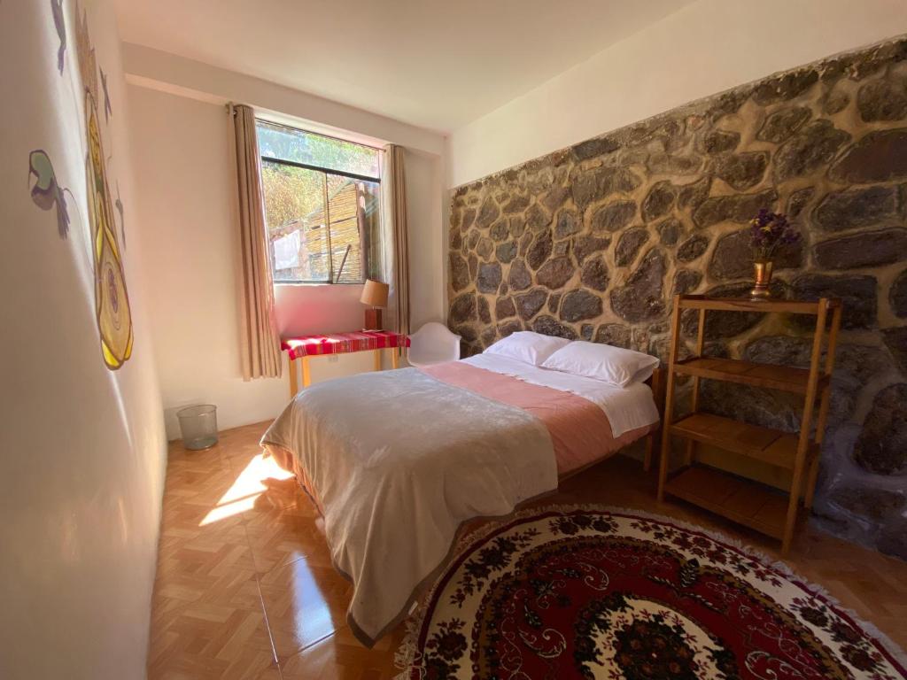 Postel nebo postele na pokoji v ubytování Colibri Wasi Pisac