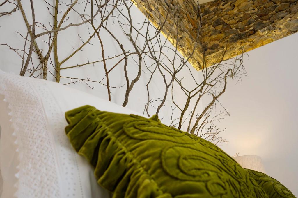a green pillow sitting on top of a table at Sparrow Sintra Nest in Sintra
