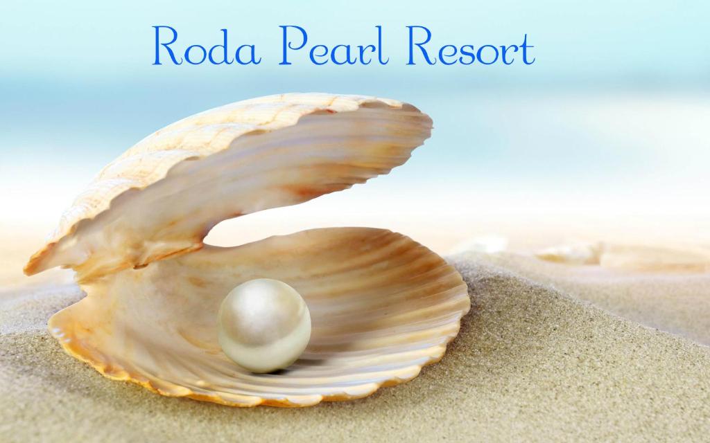 a shell with a pearl in it on the beach at Roda Pearl Resort in Roda