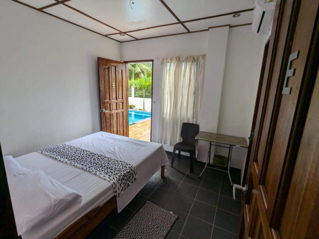 una camera con letto, scrivania e finestra di PalomaVilla Resort a Panglao