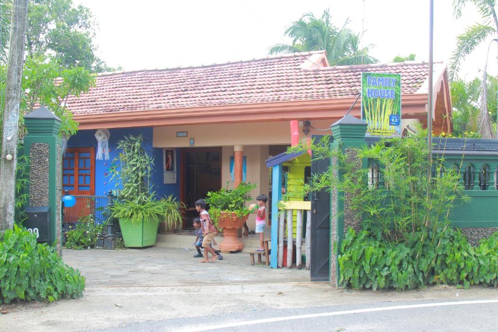 a house with two children walking in front of it at Familyhouse in Negombo