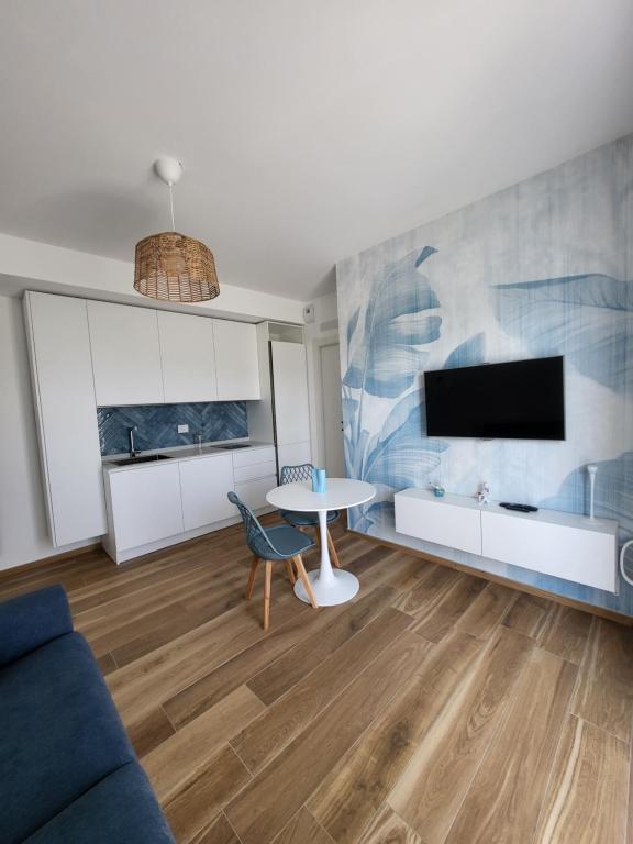 a living room with a table and a tv at Casa Isabel Charm Apartment in San Benedetto del Tronto