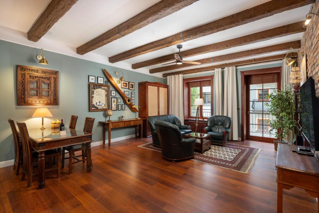 a living room with a table and chairs at Old House Apartments 2 Poznań in Poznań