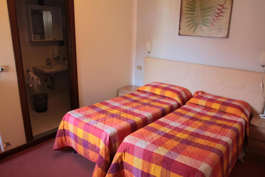 Postel nebo postele na pokoji v ubytování Hotel Domodossola