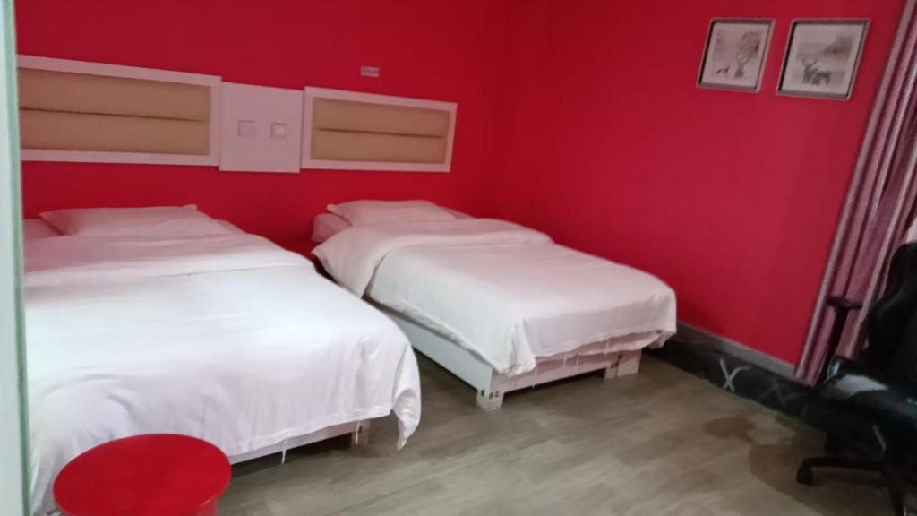 A bed or beds in a room at Weiyi Boutique Hotel