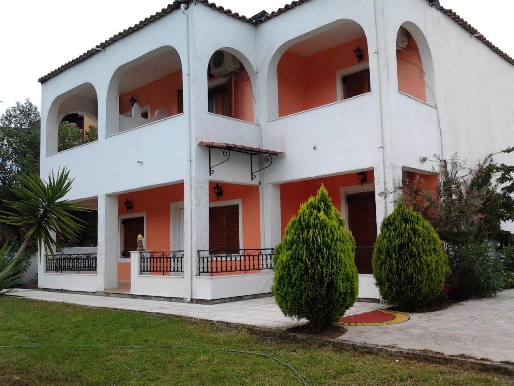 a large white building with orange trim at Digkas Apartments in Kato Korakiana