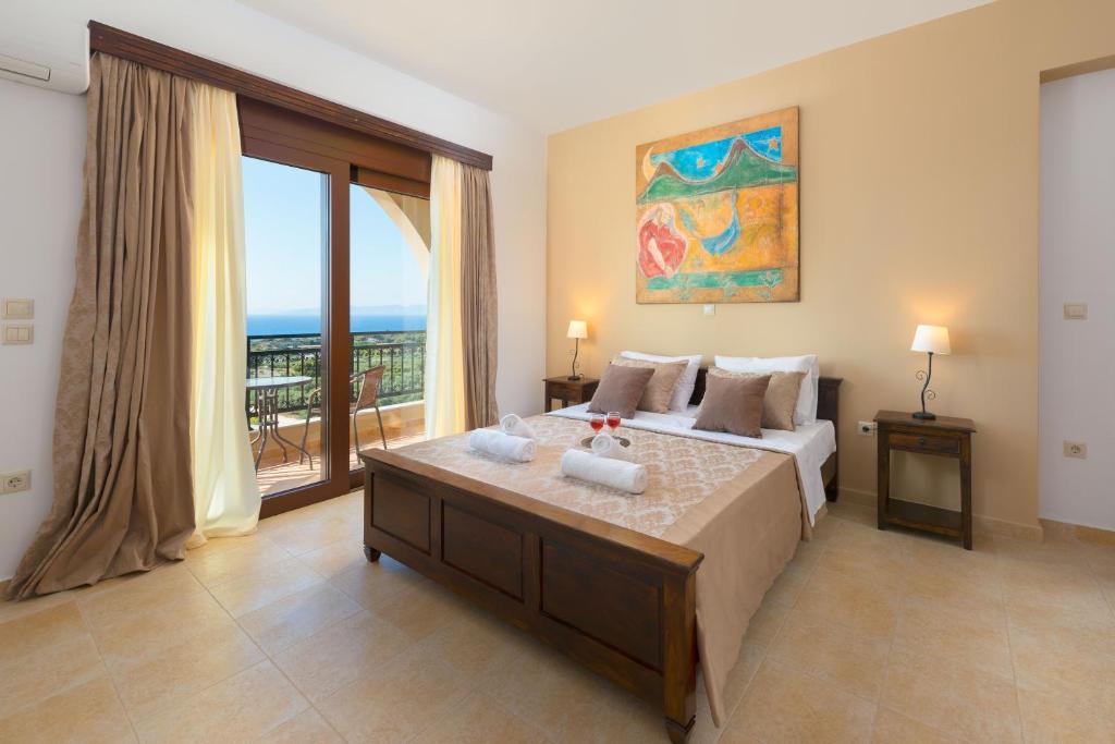 A bed or beds in a room at Butterfly Villa with stunning Sea and Valley Views