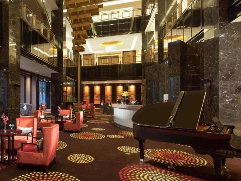 a hotel lobby with a piano and a bar at Xi'an Airport Hotel in Xianyang