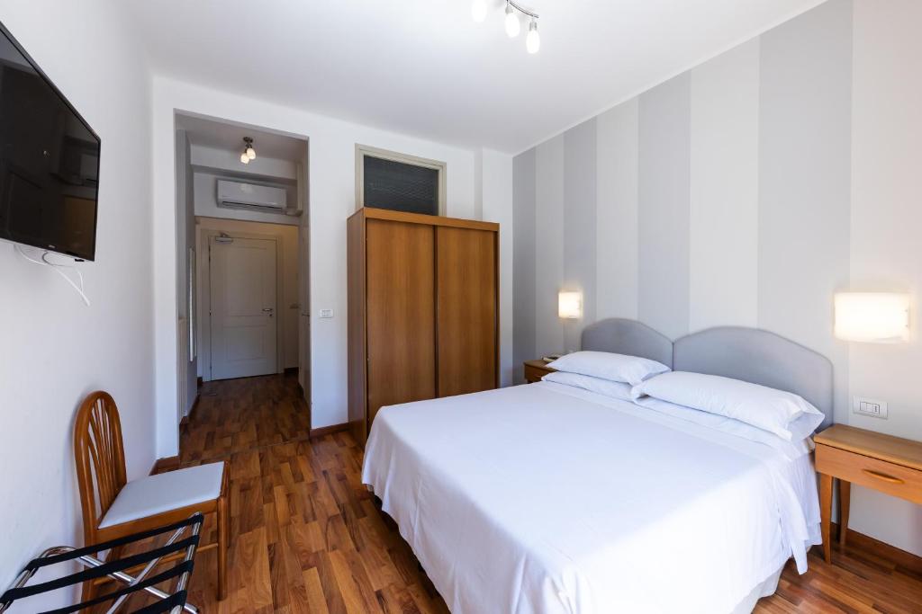 Postel nebo postele na pokoji v ubytování Hotel Beau Rivage