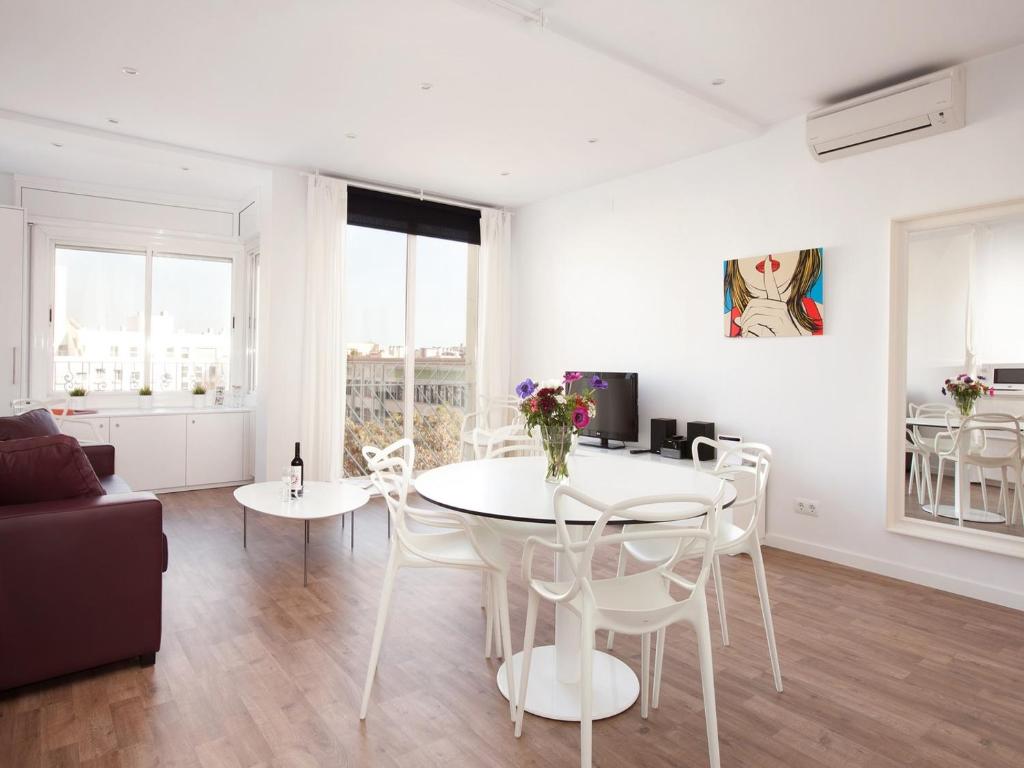 a living room with a white table and chairs at Stay U-nique Apartments Sant Pau in Barcelona