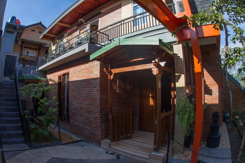 un edificio de ladrillo con balcón y escalera en Crown Guest House, en Ambarawa