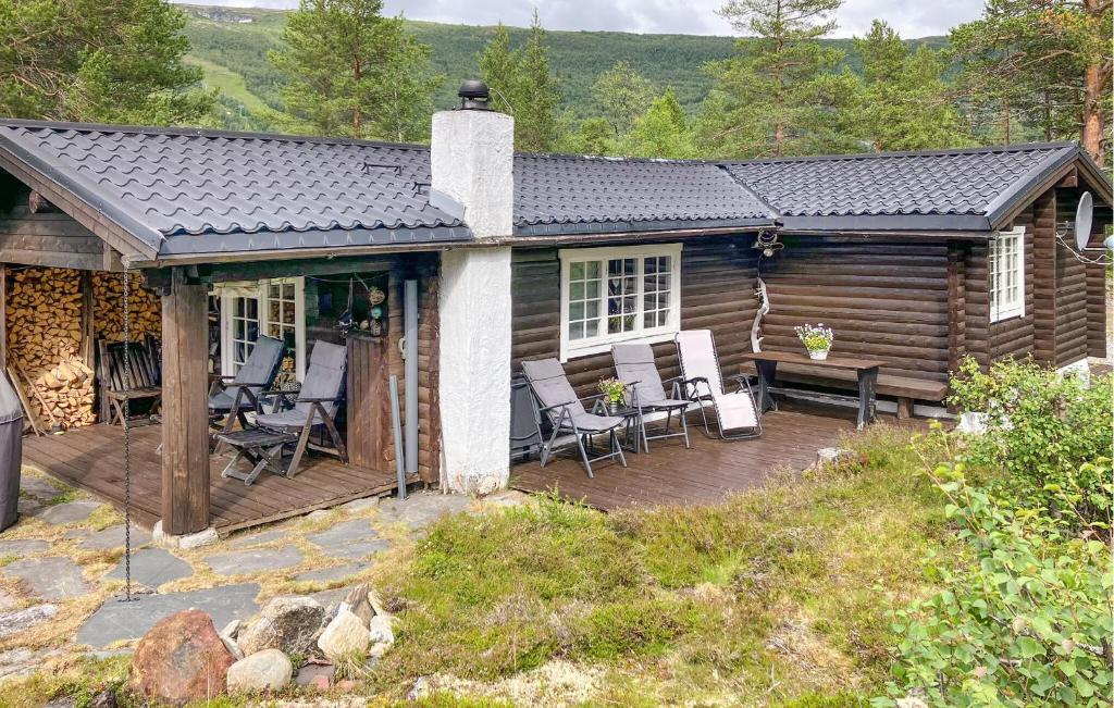 una baita con sedie e un ponte di Beautiful Home In Bjorli a Bjorli