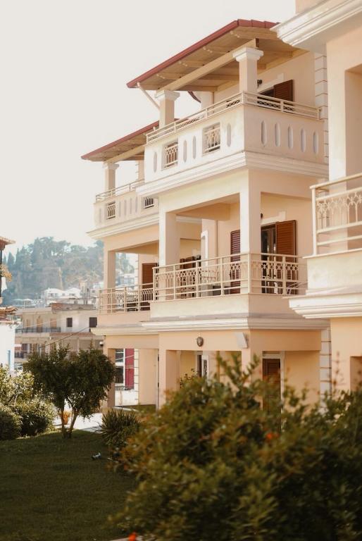 a large white building with balconies on it at Sifakis House in Parga