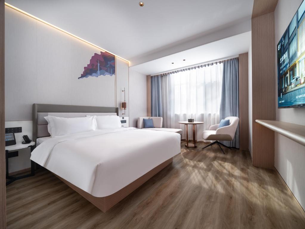 Postel nebo postele na pokoji v ubytování Elong Hotel City Hall Branch