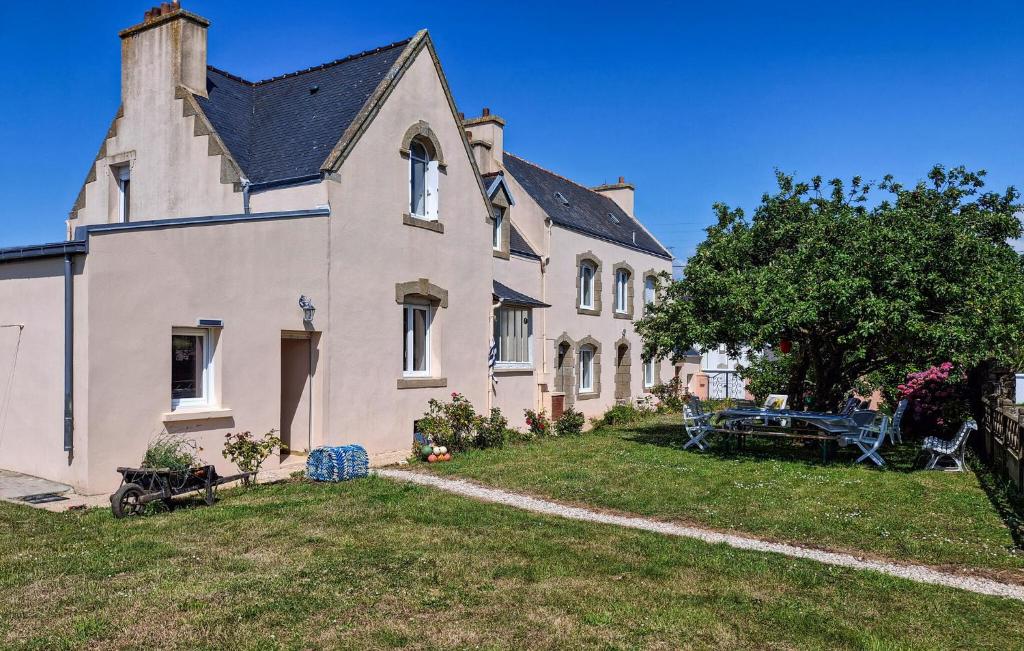 a large white house with a large yard at 3 Bedroom Amazing Home In Plouhinec in Plouhinec