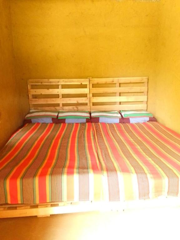 Postel nebo postele na pokoji v ubytování Hideout Rawana Meenure