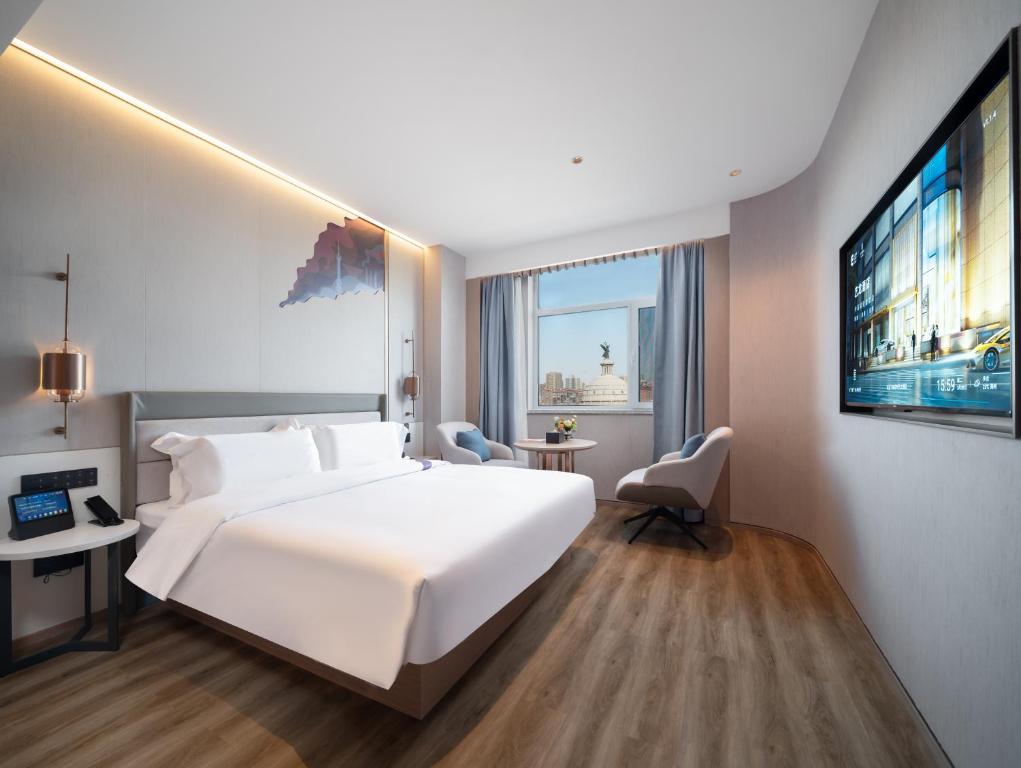 Postel nebo postele na pokoji v ubytování Elong Hotel City Hall Branch