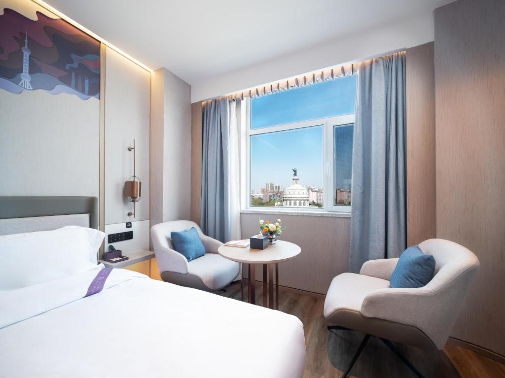 Postel nebo postele na pokoji v ubytování Elong Hotel City Hall Branch