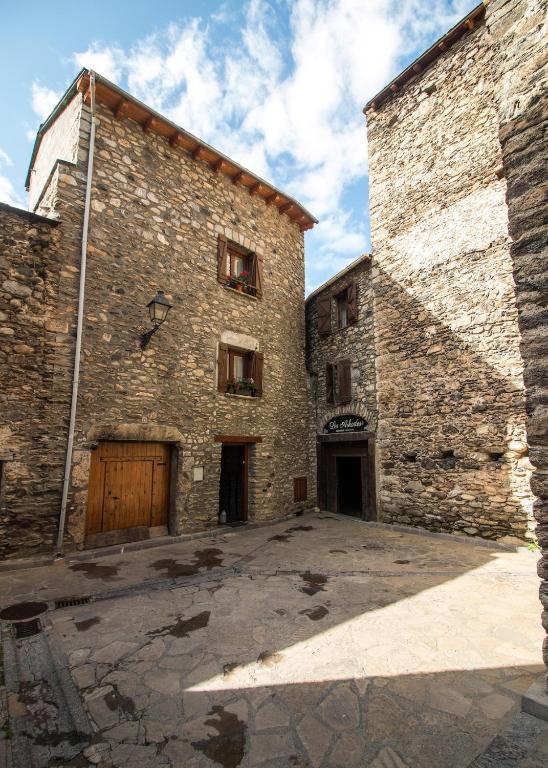 a large brick building with two entrances and two doors at Apartmento A in Benasque