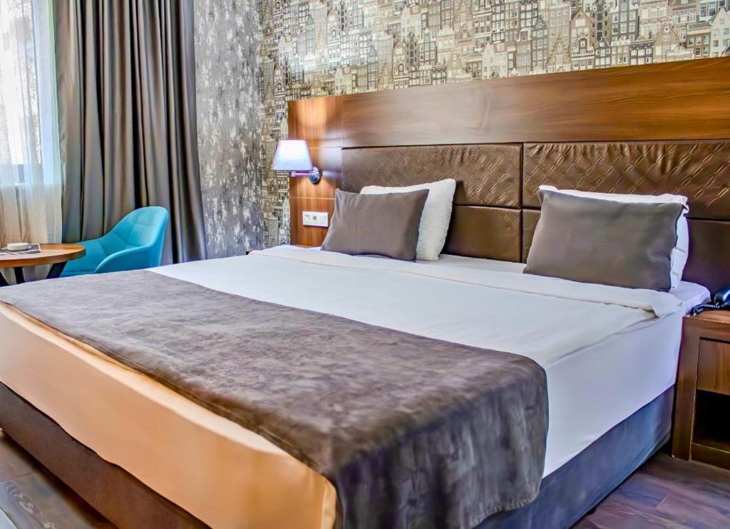 Postel nebo postele na pokoji v ubytování Ma City Hotel