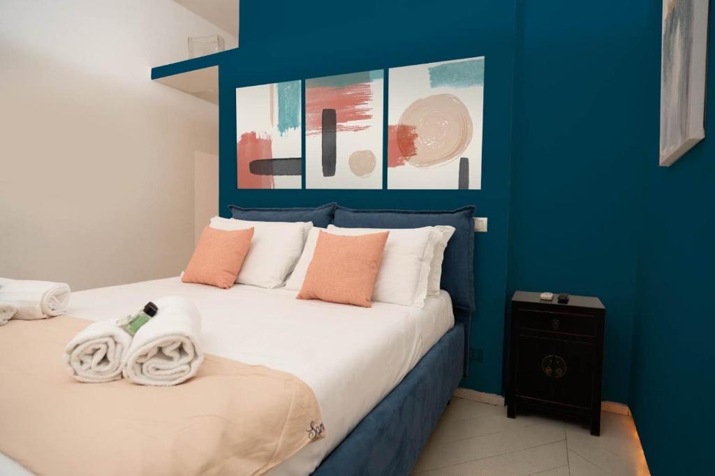 a blue bedroom with a bed with towels on it at Pantheon Luxury Apartment in Rome