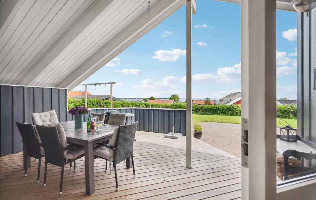 a patio with a table and chairs on a deck at Cassiopeia in Sjølund