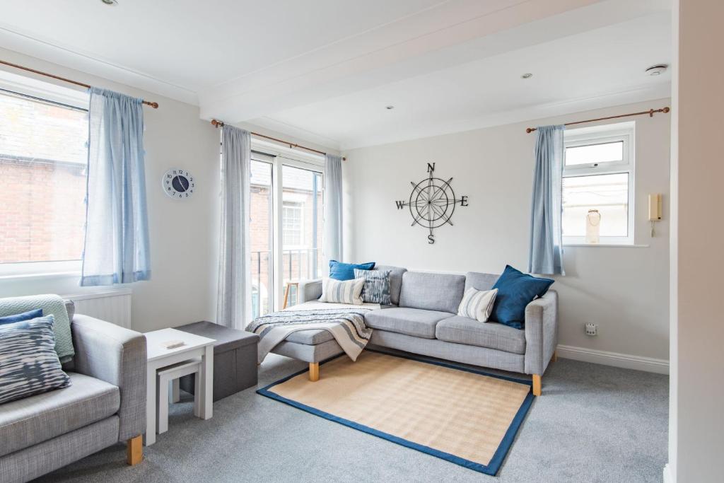a living room with two couches and a table at The Landing in Hythe