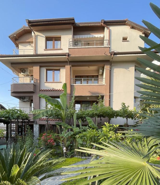 a tall building with plants in front of it at Kastela Guest House in Chernomorets
